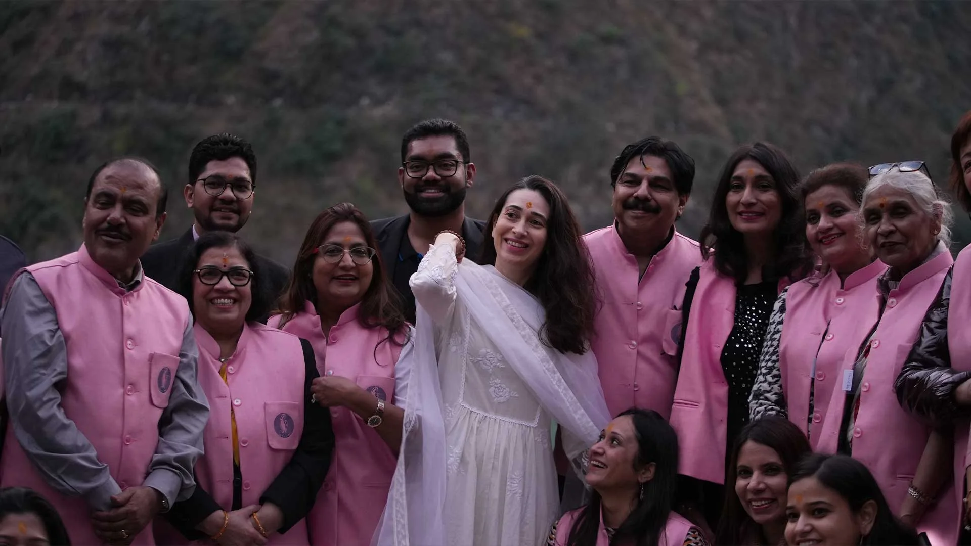 Karishma kapoor standing with doctors for livogen bus yatra